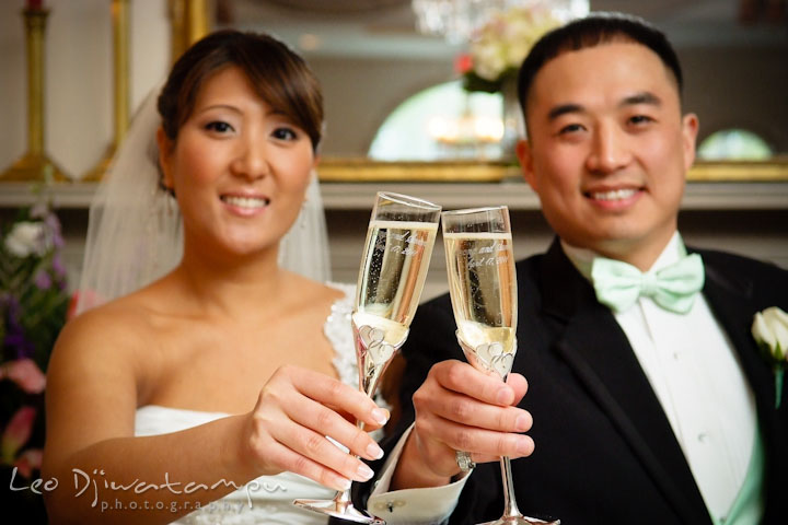Bride and groom raised the champagne glasses and toast. Ceresville Mansion Frederick Maryland Wedding Photo by wedding photographer Leo Dj Photography